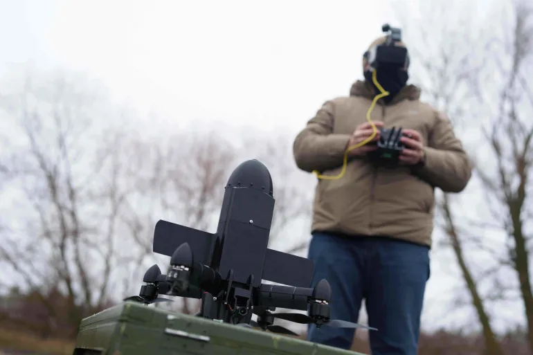 Serviceman preparing an interceptor drone before launch.