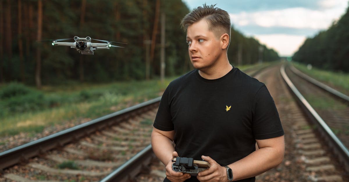 Drone operator piloting from a rugged outdoor field environment.