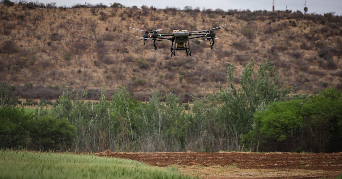 Agricultural drone flying above a wide field during active operations.